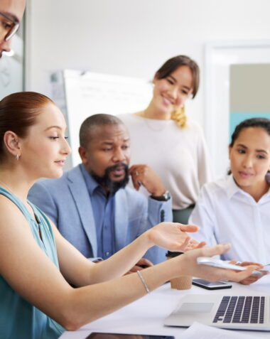 Business people, mentor and laptop in office for coaching, collaboration or planning marketing stra.