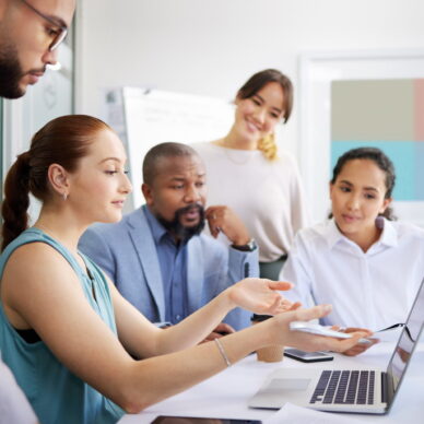 Business people, mentor and laptop in office for coaching, collaboration or planning marketing stra.