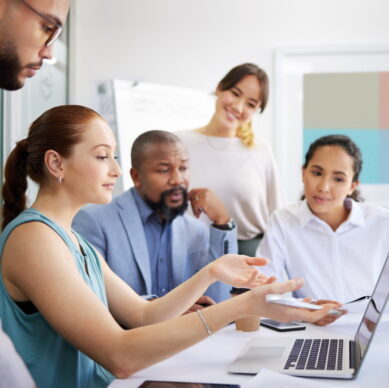 Business people, mentor and laptop in office for coaching, collaboration or planning marketing stra.