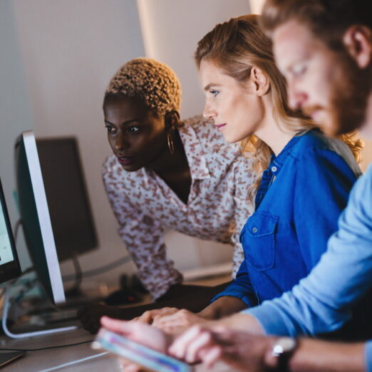 Programmers cooperating at  IT company developing apps