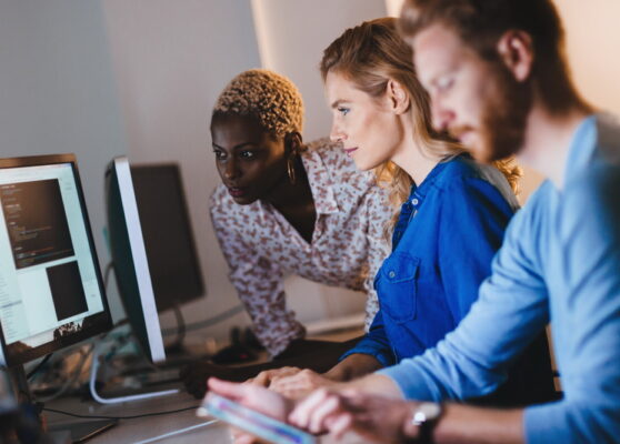 Programmers cooperating at  IT company developing apps
